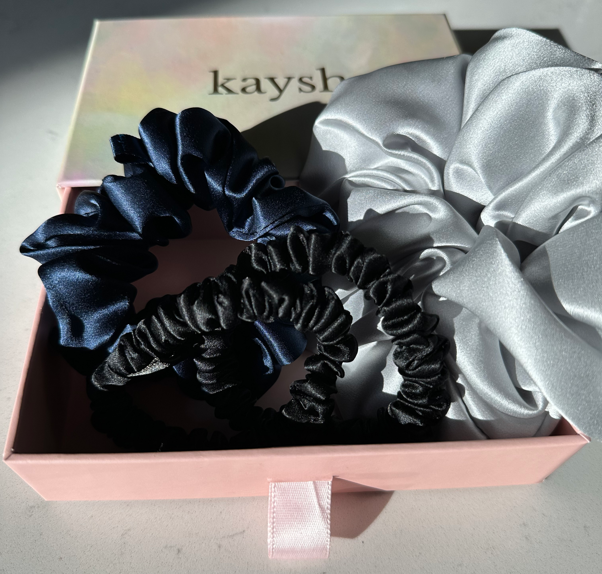 100% mulberry silk scrunchies inside a gift box. Shiny, luxurious and soft to touch. 