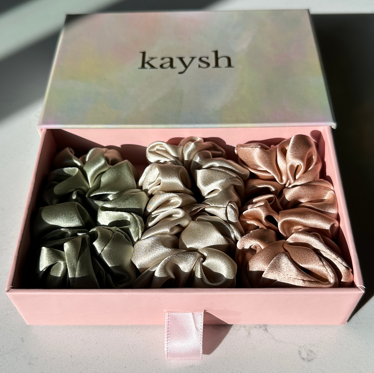 100% mulberry silk scrunchies inside a gift box. Shiny, luxurious and soft to touch. 