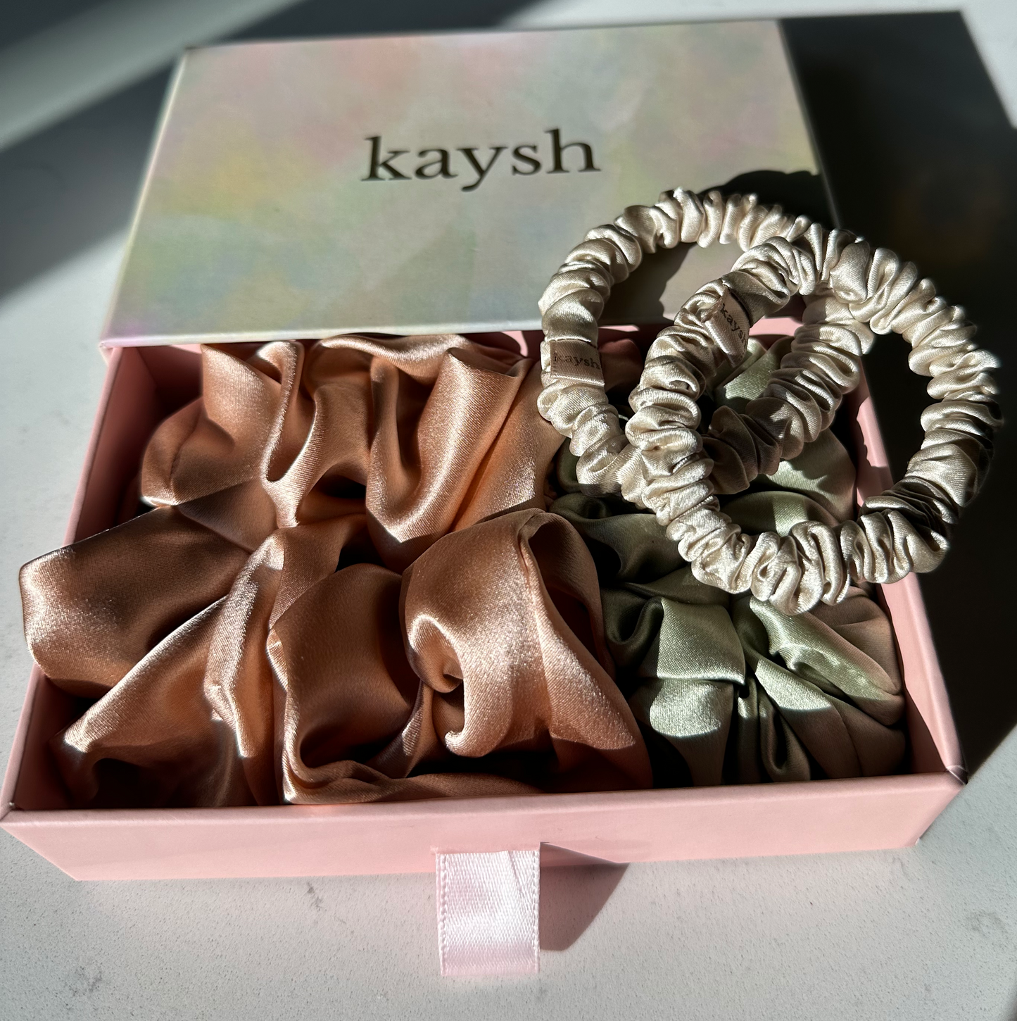 100% mulberry silk scrunchies inside a gift box. Shiny, luxurious and soft to touch. 